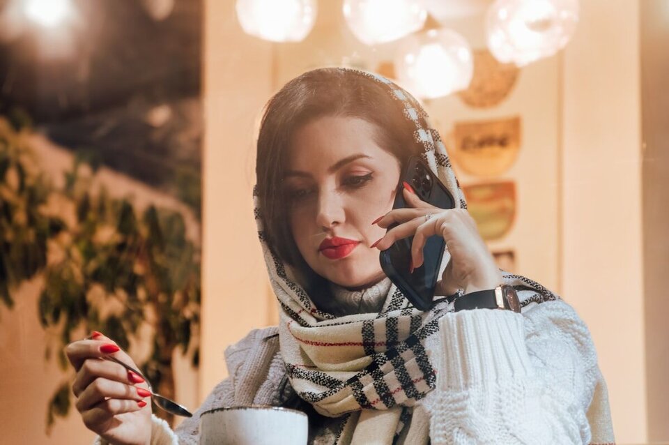 Person talking with a phone psychic from home